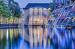 Church and housing reflecting during the blue hour