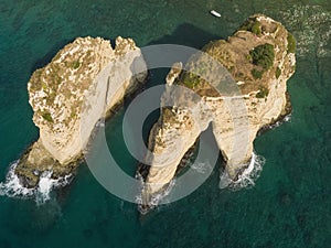 Rouche rocks in Beirut, Lebanon in the sea during daytime. Pigeon Rocks in Mediterranean sea.