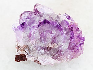 rough Amethyst crystal druse on white marble