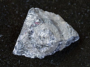 rough antimonite stone on dark background