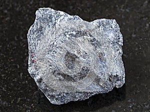 rough antimony ore (Stibnite) stone on dark