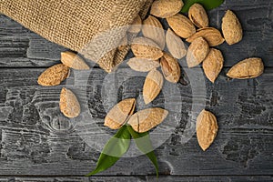 A rough bag with crumbling almonds in the shell