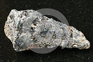 rough biotite nepheline syenite stone on dark