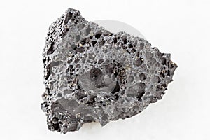 rough black Pumice rock on white marble