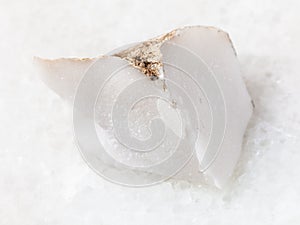 rough cacholong (white opal) stone on white photo