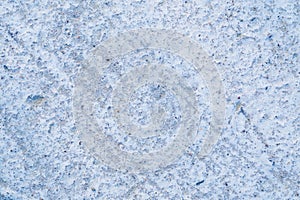 Rough cement background with the texture of a gray concrete wall. Non-uniform surface with oblique lines.