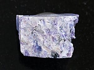 rough charoite stone on dark background