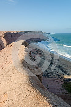 Rough coast line with towering cliffs and wild ocean in Angola