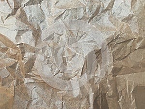 Rough crumpled paper as a unique abstract texture - background.