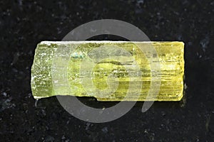 rough crystal of Heliodor (yellow beryl) on dark
