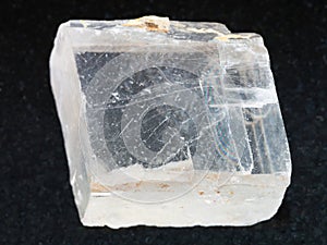 rough crystal of Iceland spar gemstone on dark