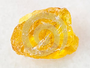 rough crystal of sulphur stone on white marble