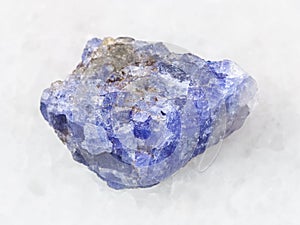 rough crystal of Tanzanite gemstone on white