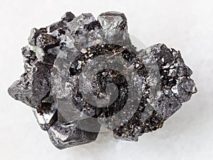 rough crystalline Magnetite stone on white marble photo