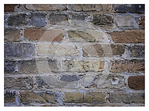 Rough hewn chiseled red brick wall for abstract, textured background. photo
