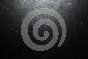 Rough, dark stone background lit by spotlight