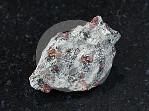 rough eclogite stone on dark background photo