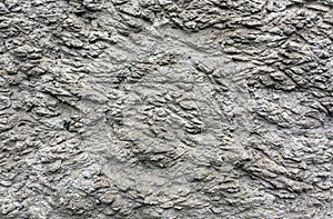 Rough gray plaster wall texture.