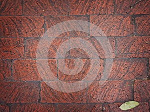 Rough hewn chiseled red brick wall for abstract, textured background.