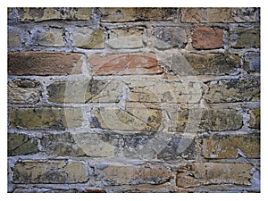 Rough hewn chiseled red brick wall for abstract, textured background. photo