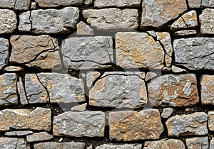 Rough-hewn stone wall composed of irregularly shaped rocks in