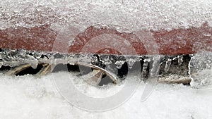 Rough icy texture with small icicles on red metal surface background