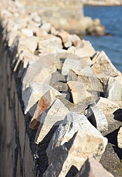 Rough and Jagged Rocks Along a Retaining Wall