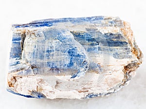 rough kyanite stone on white marble