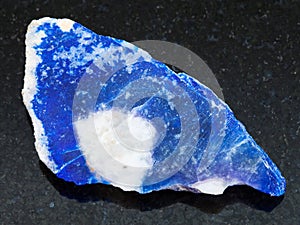 rough lazurite (lapis lazuli) stone on dark