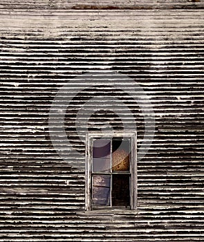 Rough looking texture of barn with old window