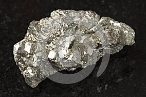 rough marcasite stone (white iron pyrite) on dark