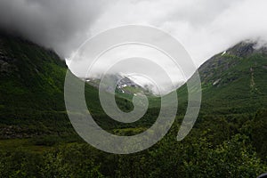 Rough mountain sides around the Trollstigen mountain pass that twists through 11 hairpin bends up the steep mountains of Romsdalen