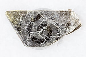 Rough muscovite common mica on white marble