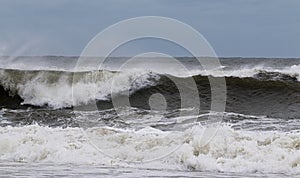 Rough ocean waves from tropical storm with heavy winds blowing the water