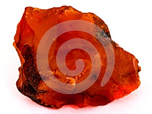 Rough red carnelian rock isolated on white