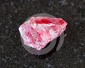 rough Rhodonite crystal on black