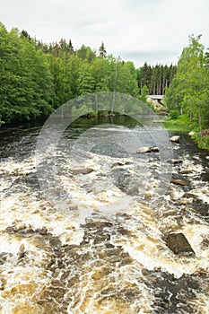 Rough river Jokelanjoki and stones in water, Kouvola, Finland photo