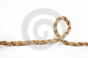 Rough rope coiled in a loop isolated on white