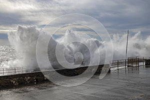 Rough sea with big waves on the piers of the Genoa seafront, Italy