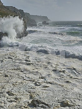 Rough sea at the coastline in FinistÃ¨re, France. Big waves breaking on cliffs in Crozon