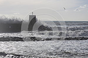 Rough sea on the pier of Recco with the lighthouse, Genoa province, Italy