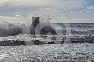 Rough sea on the pier of Recco with the lighthouse, Genoa province, Italy