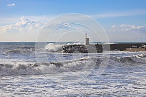 Rough sea on the pier of Recco with the lighthouse, Genoa province, Italy