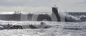 Rough sea on the pier of Recco with the lighthouse, Genoa province, Italy