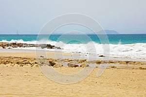 Rough sea in Playa las Cucharas with Fuerteventura island on the background, Costa Teguise, Lanzarote photo