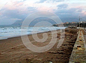 Rough sea in Sicily with promontory in the background