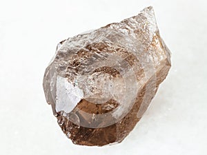 rough smoky quartz crystal on white