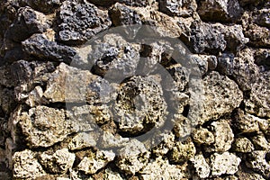 Rough stone solid wall closeup photo. Stone wall texture. Rustic stone wall of ancient building.