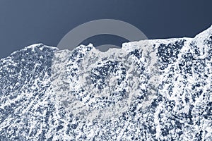 Rough structure of thin ice against a blue sky, concept of cold and winter sports
