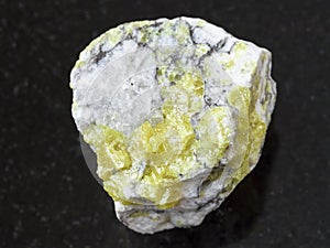 rough sulfur ore on dark background